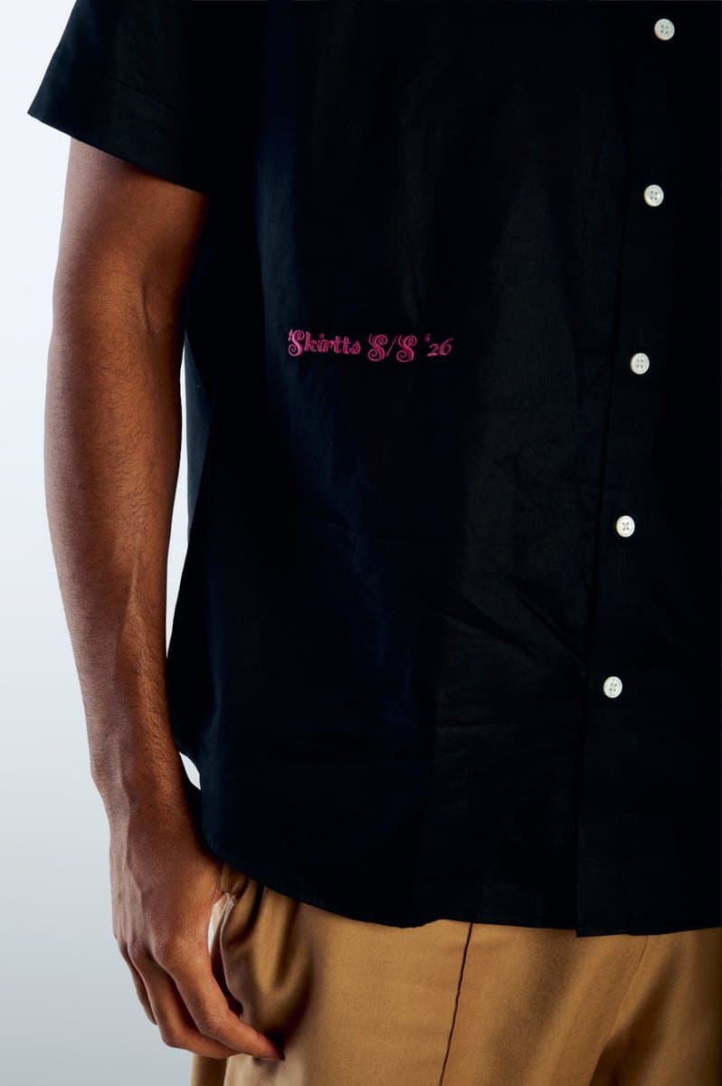 Skirtts S/S '26 embroidered in pink on the black Captain Short Sleeve Button Up